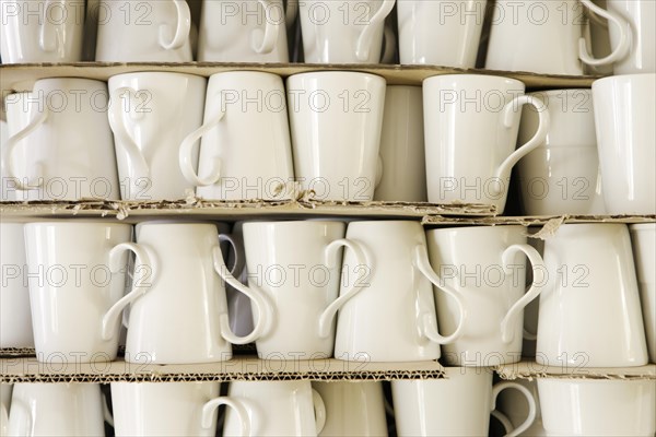 Cups piled between cardboard