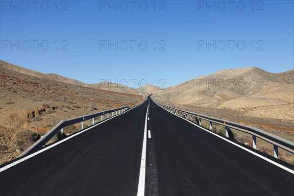 Road through a barren mountain landscape