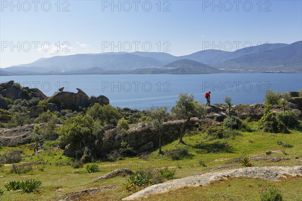 Woman wearing a backpack while hiking at Lake Bafa