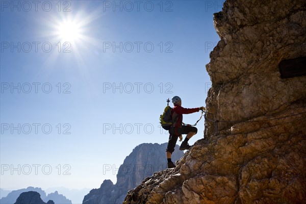 Mountain climber climbing the Marino Bianchi climbing route on Monte Cristallo to the summit of Cristallo di Mezzo