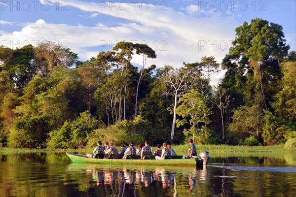 Tourist group travelling by boat through the rainforest