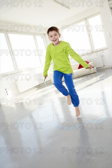 Young jumping rope in casual clothes