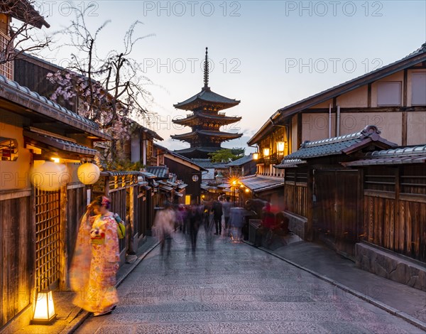 Woman in kimono and pedestrian in an alleyway
