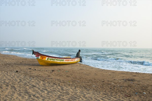 Man on a boat on a beach