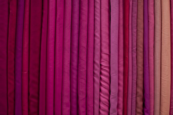 Fabrics lined up on a rack