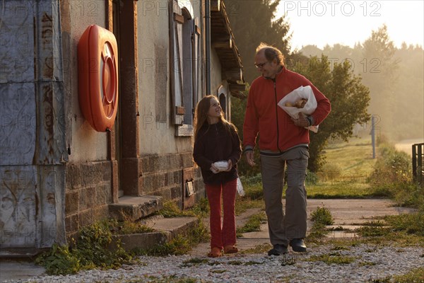 Father and daughter shopping for bread in the early morning