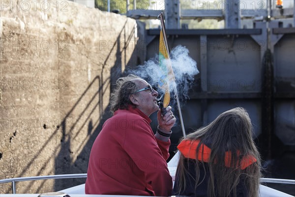 Father and daughter in the lock chamber while rising in a lock