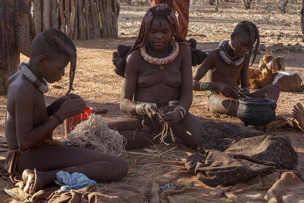 Traditionally dressed Himba people in the Otjikandero Himba Orphan Village