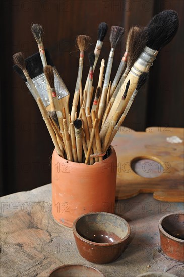 Various hair brushes in a cup