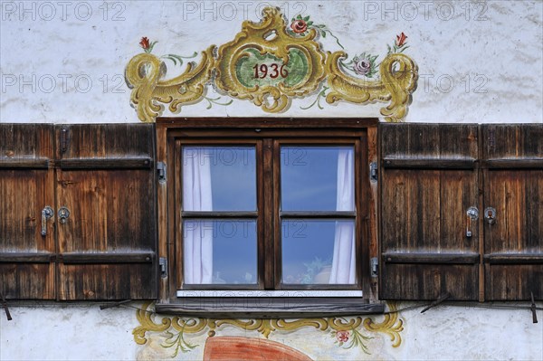 Window with shutters and Lueftlmalerei murals from 1936 on a farmhouse
