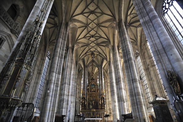 Vaulted ceiling and chancel of the late-gothic three-naved hall church