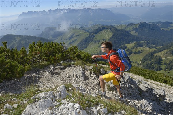 Hiker ascending Geigelstein Mountain