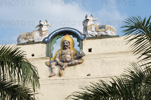 Colourful guardian figure flanked by Nandi