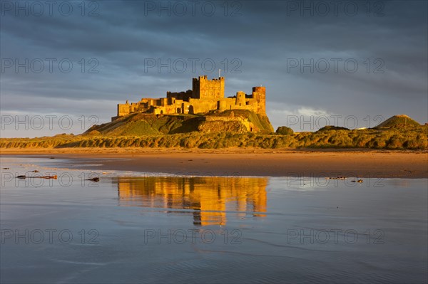 Bamburgh Castle and its reflection in the last light of the day