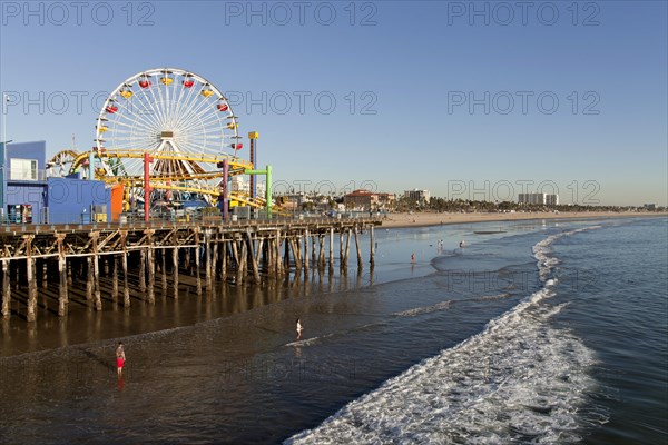 Ferris wheel at Pacific Park on the Santa Monica Pier and the beach in Santa Monica