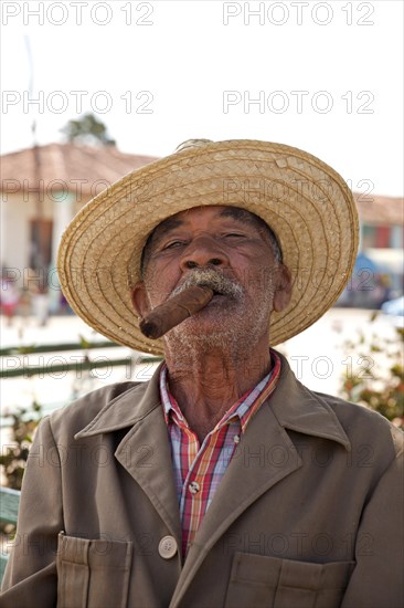 Elderly man smoking a cigar