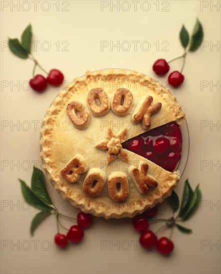 Cherry pie with "Cook Book" written on it in pastry