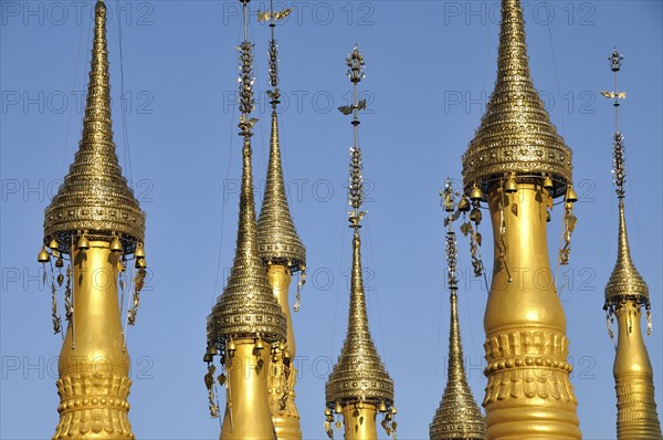 Gold-coloured stupas with golden hti