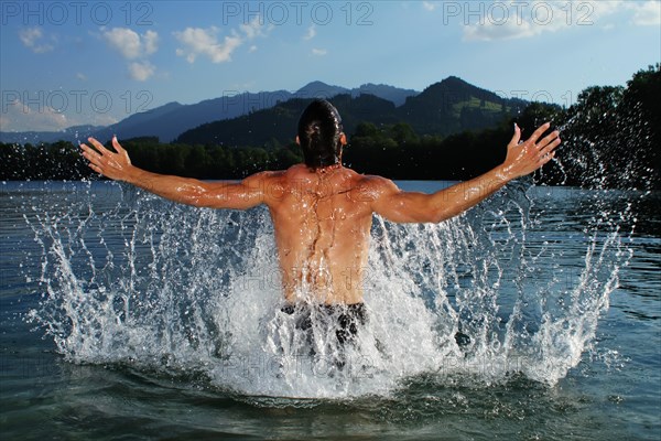 Man splashing about in a lake in Sonthofen
