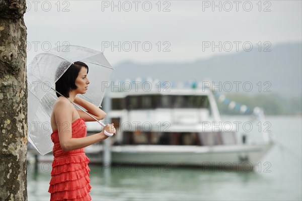 Woman with umbrella outside in a summer rain