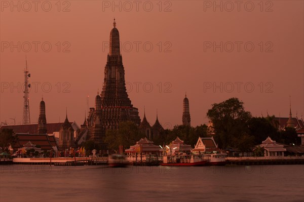 Wat Arun or "Temple of Dawn" on the Chao Phraya River at sunrise