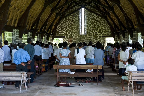 Believers attending a mass in a stone church