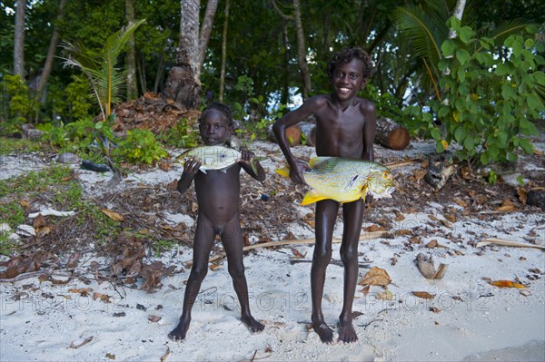 Boys proudly showing the fish they caught