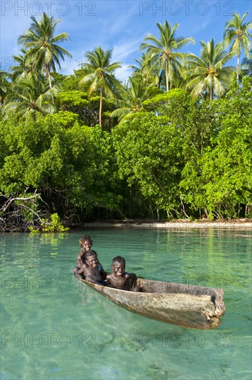 Local boys in a canoe in the Marovo Lagoon