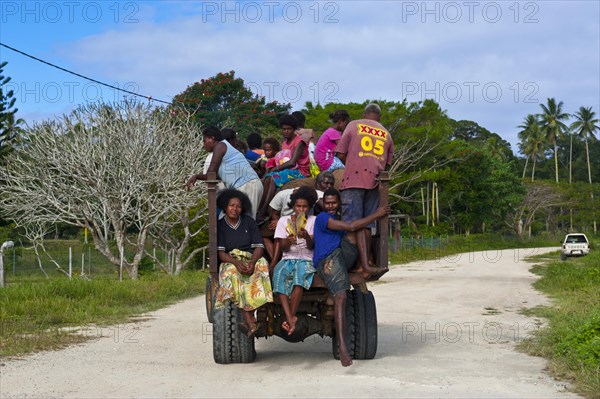 Fully loaded tractor transporting field workers