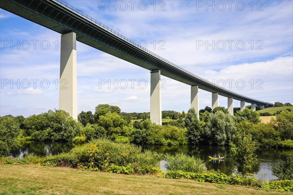 Paddler with kayak on the Ruhr under Ruhrtal bridge