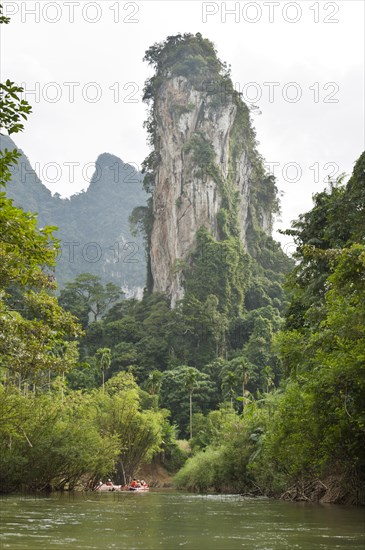 Kayakers rowing on a river through the jungle