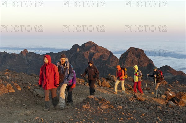 Group of hikers on a hiking trail just before the summit of Piton des Neiges Mountain