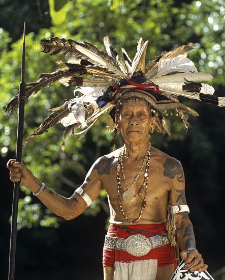 Head hunter of the ethnic group of the Iban people with a spear