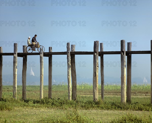 Cyclist on a teak bridge