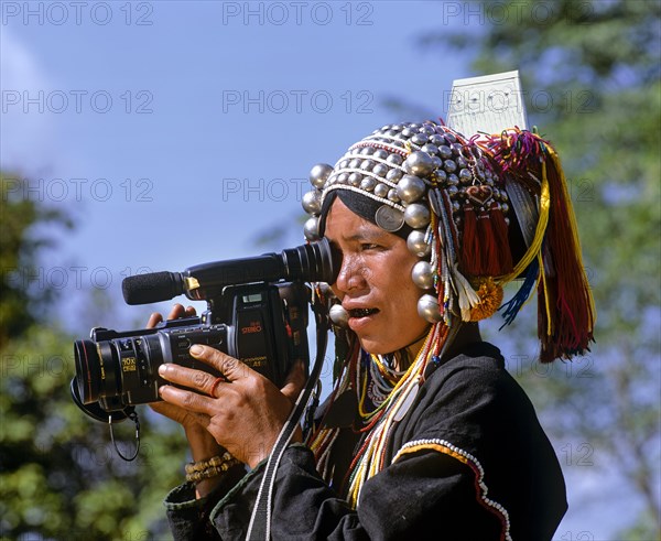 Akha woman in traditional costume and headdress with silver bells