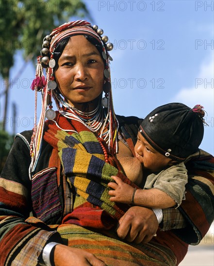Young Akha woman breastfeeding baby