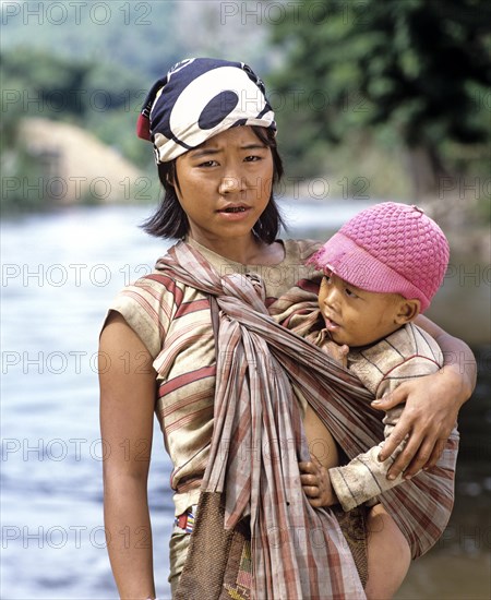 Young Karen woman breast-feeding her child