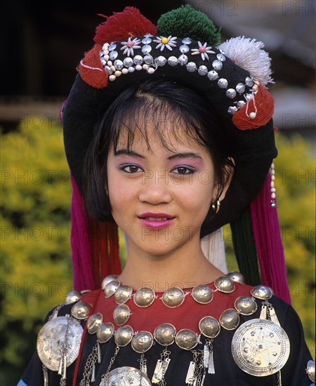 Lisu girl wearing a colourful headdress and the traditional costume of the mountain people