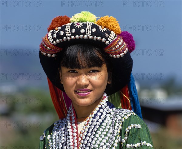 Lisu girl wearing a colourful headdress and the traditional costume of the mountain people