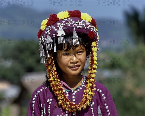 Lisu girl wearing a colourful headdress and the traditional costume of the mountain people