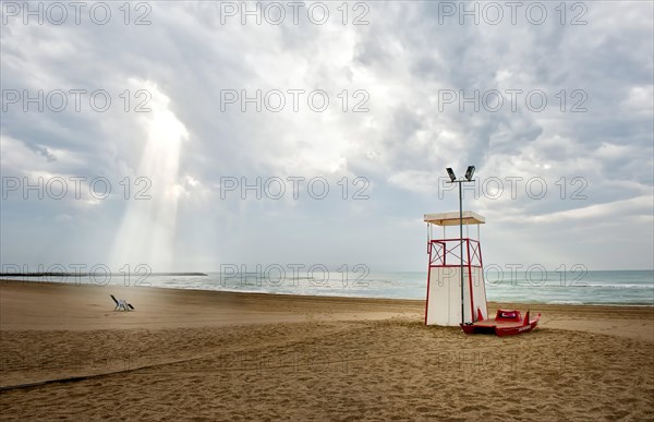 Observation tower and deck chair on the beach