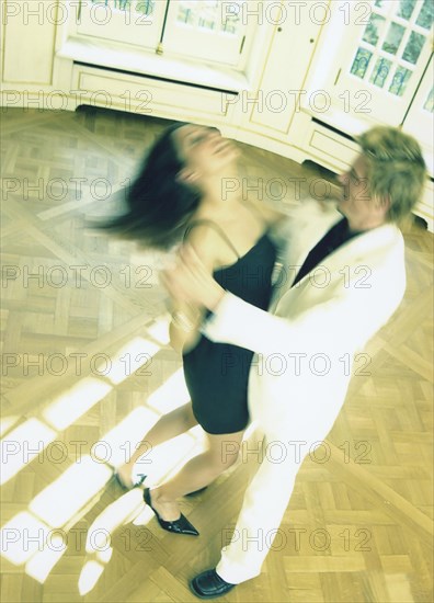 Dancing couple on herringbone parquet flooring