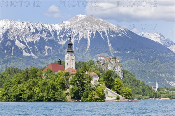 Blejski Otok Island with St. Mary's Church in Lake Bled and The Karawanks mountain range in Bled