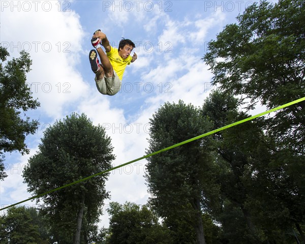 Athlete jumping on a slackline