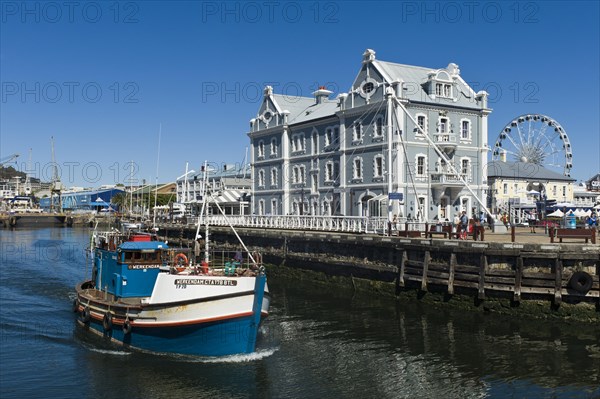 Fishing cutter in front of the African Trading Port building