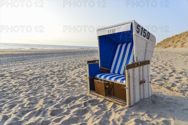 Roofed wicker beach chair on the beach