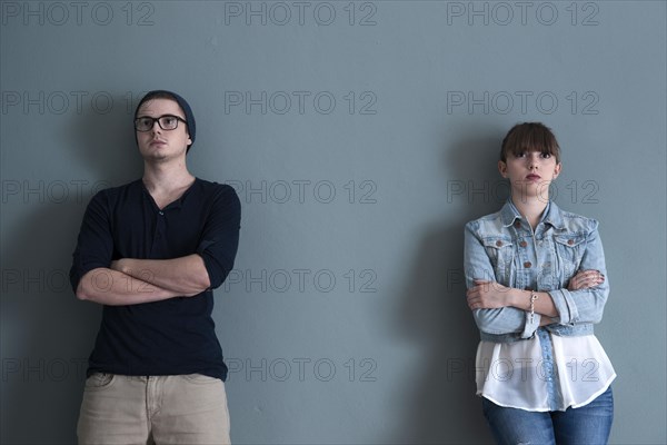 Young couple leaning on a wall