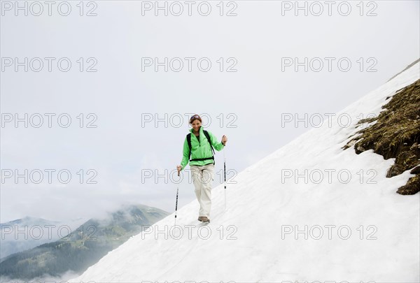 Couple moving over a snow field during their hike to Mt. Neunerkoepfle