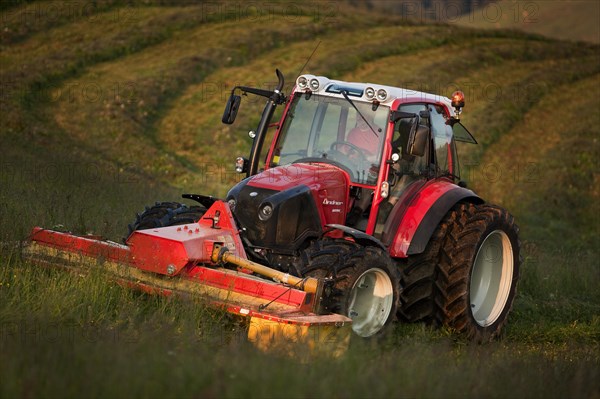 Tractor mowing hay