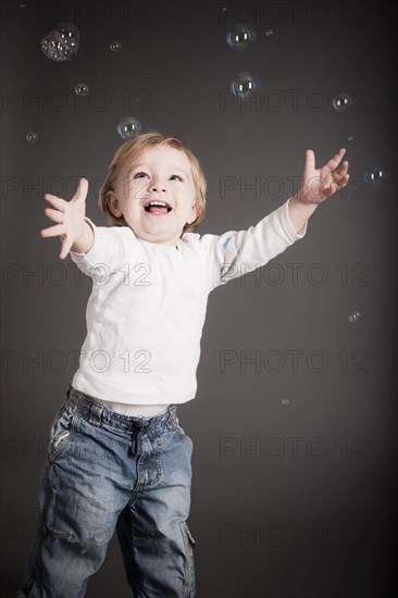 Young boy playing with soap bubbles